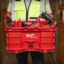 This is an image of a person holding a red Milwaukee PACKOUT toolbox with power tools, showcasing Kennedys Welding Supplies in Derwent Park TAS offering tool shop and welding specialists services