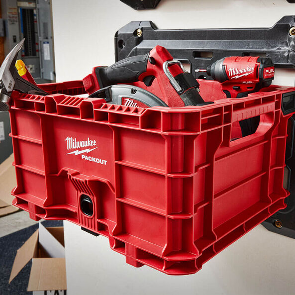 This is an image of a red Milwaukee PACKOUT tool storage box holding power tools, featured by Kennedys Welding Supplies in Derwent Park, TAS, offering tool shop and welding specialist services.