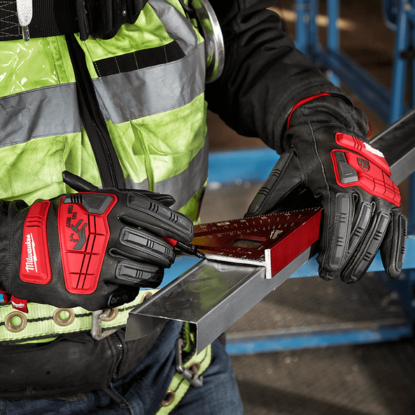 This is an image of a worker wearing red Milwaukee gloves using a square tool to measure metal, representing Kennedys Welding Supplies in Derwent Park, TAS, offering tool shop, laser cutting, power tool repairs, and welding specialists