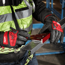 This is an image of a worker wearing red Milwaukee gloves using a square tool to measure metal, representing Kennedys Welding Supplies in Derwent Park, TAS, offering tool shop, laser cutting, power tool repairs, and welding specialists