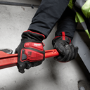 This is an image of a person wearing Milwaukee protective gloves holding a red pipe wrench, showcasing tool use at Kennedys Welding Supplies in Derwent Park, TAS, offering tool shop and welding services