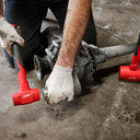This is an image of a person using red power tools to repair mechanical parts, representing Kennedys Welding Supplies in Derwent Park TAS offering tool repairs and welding services.