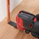 This is an image of a power tool with a red and black handle cutting wood around a copper pipe, highlighting Kennedys Welding Supplies services like power tool repairs and tool shop in Derwent Park, TAS