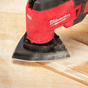 This is an image of a red Milwaukee power tool sanding wood, offered by Kennedys Welding Supplies in Derwent Park, TAS, specializing in tool shop and power tool repairs