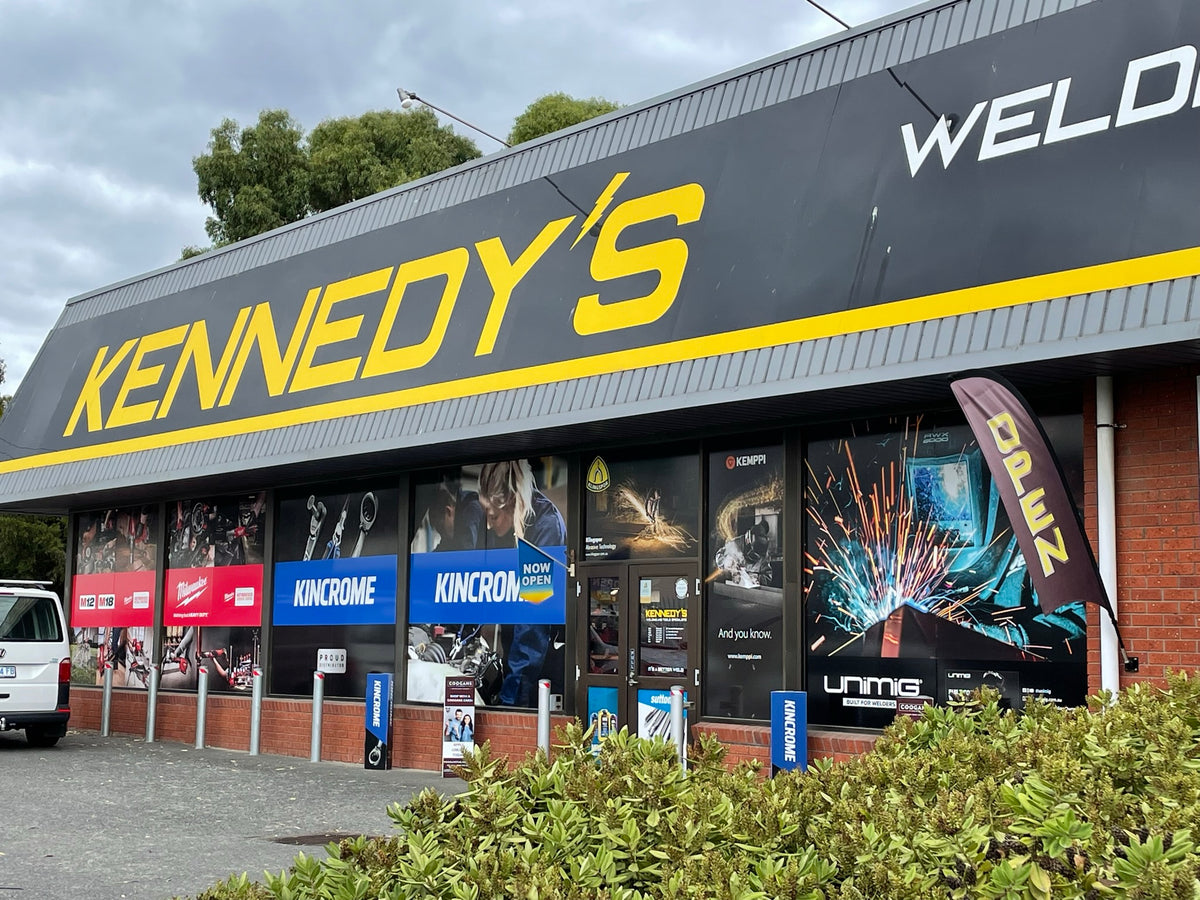 This is an image of Kennedys Welding Supplies store exterior in Derwent Park TAS, featuring brand signage and open flag, offering welding specialists, tool shop, and power tool repairs.