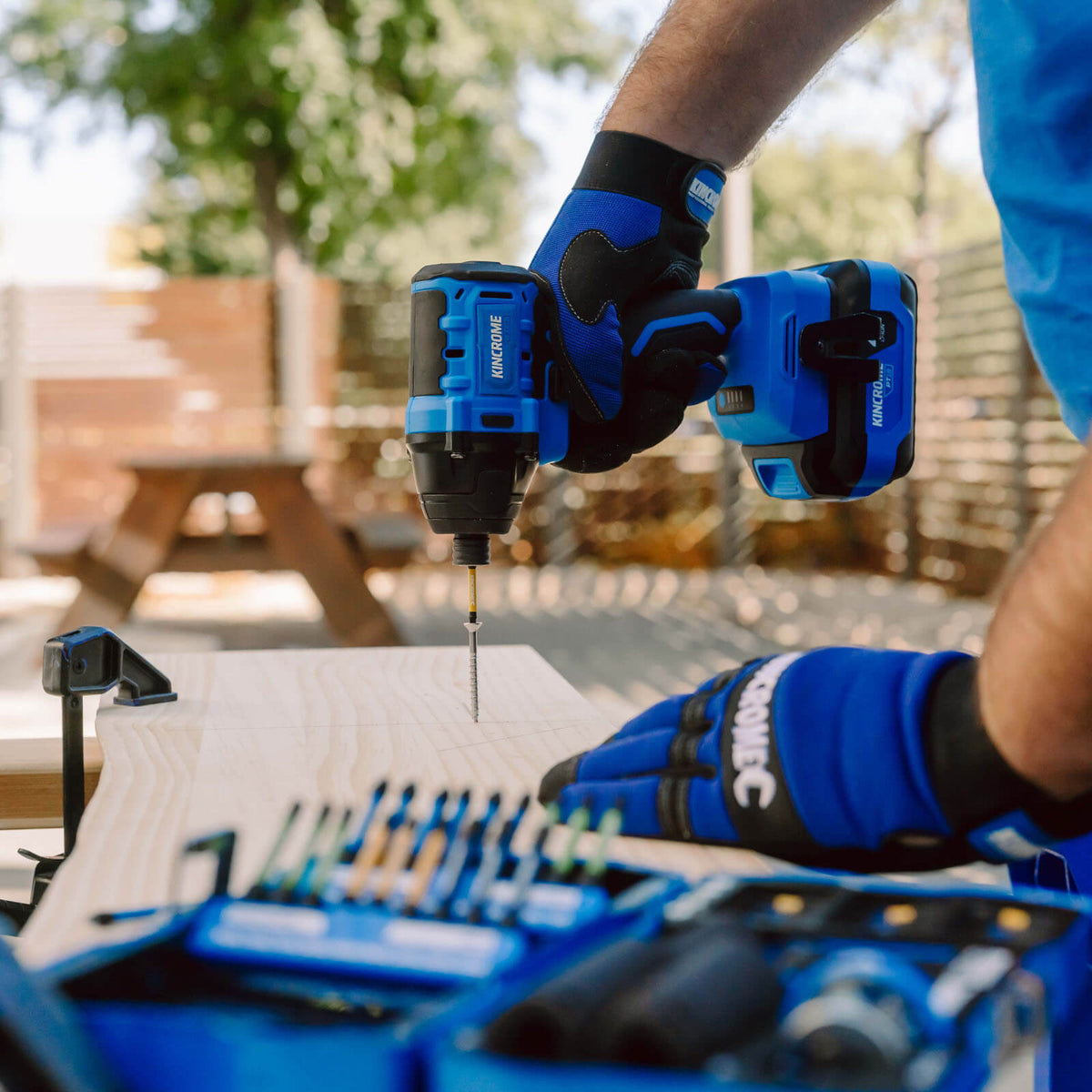 This is an image of a person using a Kincrome drill on wood, showcasing quality tools from Kennedys Welding Supplies in Derwent Park TAS