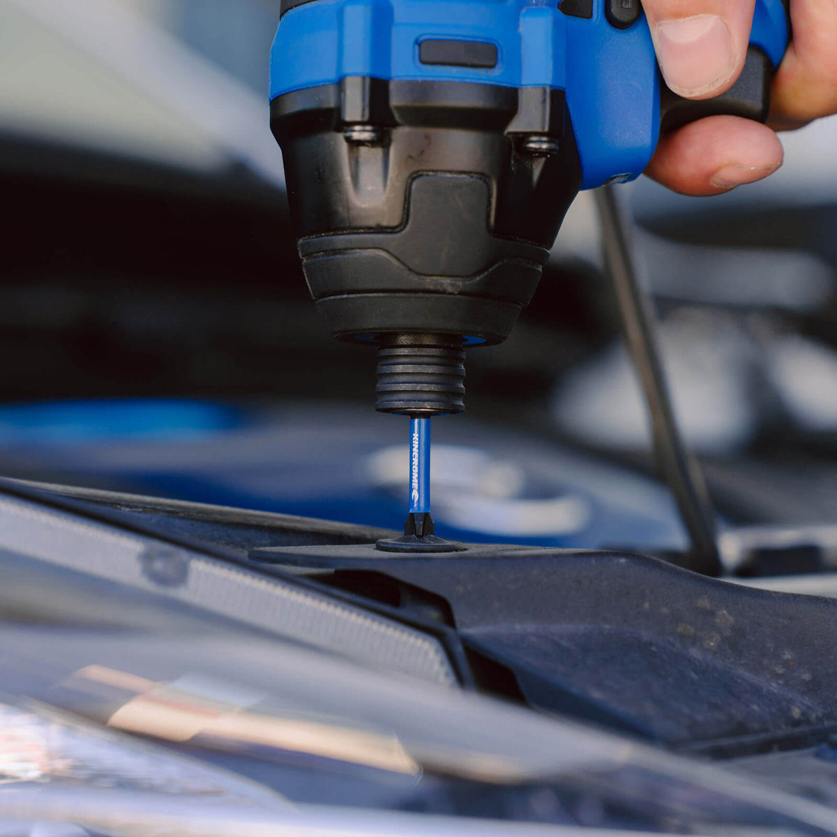 This is an image of a close-up of a blue and black power tool bit drilling into a metal surface, showcasing precision tool use by Kennedys Welding Supplies in Derwent Park TAS, offering tool shop and power tool repairs.