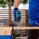 This is an image of a person using a blue cordless drill to screw wood, showcasing Kennedys Welding Supplies in Derwent Park TAS, tool shop and welding specialists.