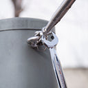 This is an image of a chrome Kincrome wrench tightening a bolt on a metal pipe, featured by Kennedys Welding Supplies in Derwent Park TAS, offering tool shop and welding specialist services.