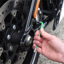This is an image of a hand using a green L-shaped wrench tool on a motorcycle wheel, showcasing Kennedys Welding Supplies in Derwent Park TAS, tool shop and power tool repairs