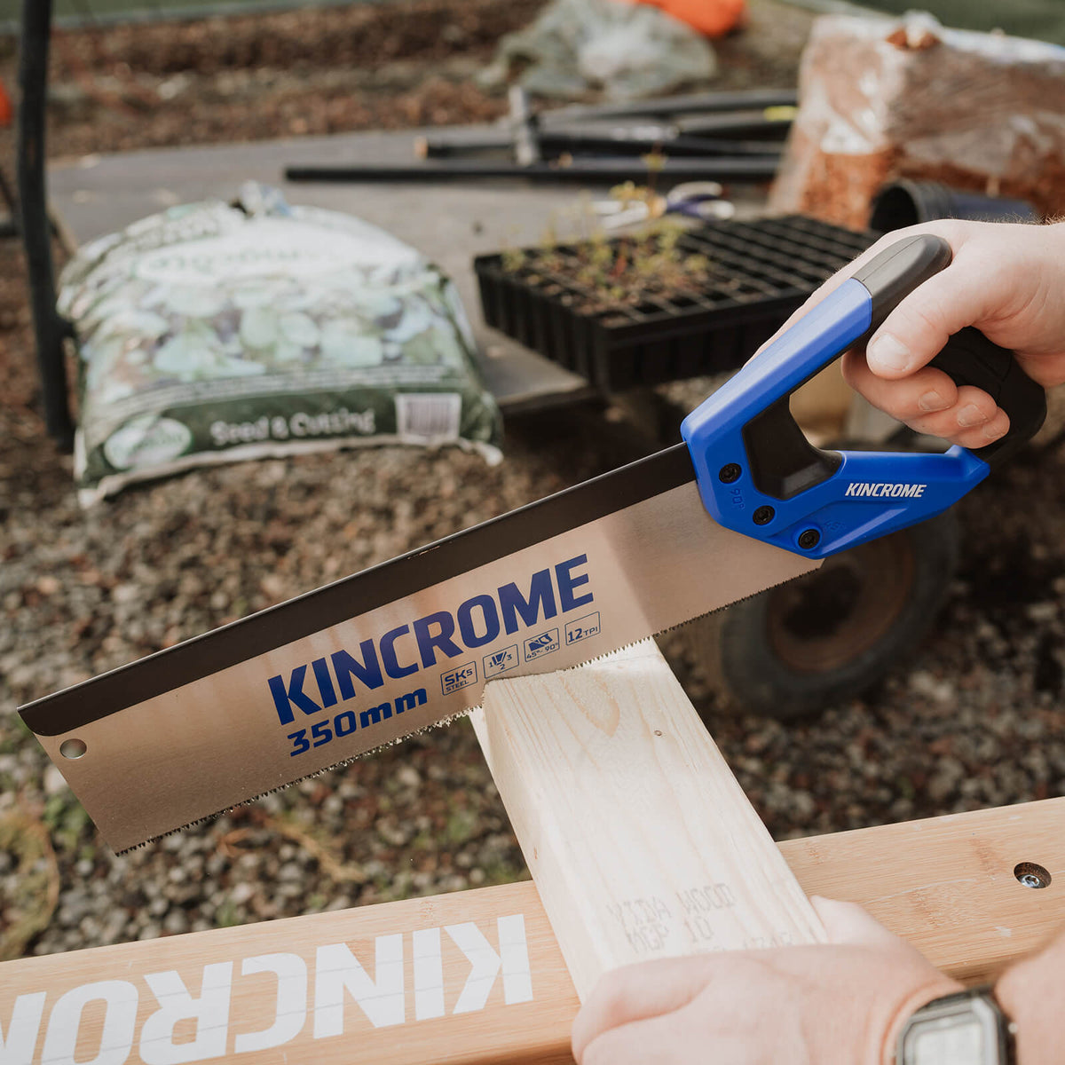 This is an image of a Kincrome 350mm hand saw cutting wood, offered by Kennedys Welding Supplies in Derwent Park TAS, Tool Shop and Welding Specialists