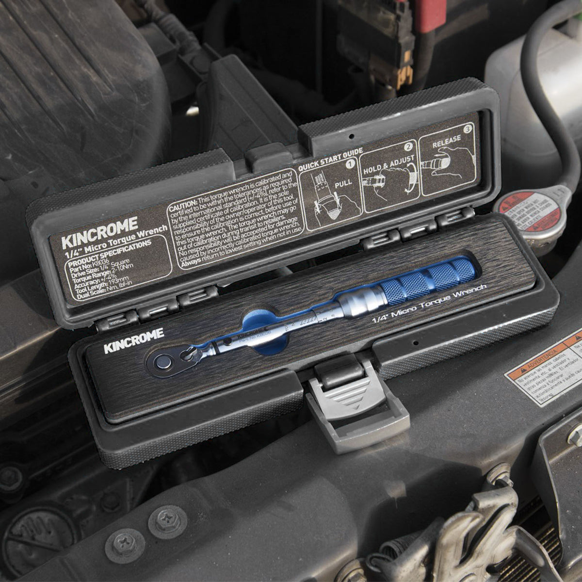 This is an image of a Kincrome 1/4" Micro Torque Wrench in a black case on a car engine, sold by Kennedys Welding Supplies Derwent Park TAS
