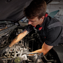 This is an image of a technician repairing a car engine at Kennedys Welding Supplies in Derwent Park TAS, specializing in tool shop and power tool repairs