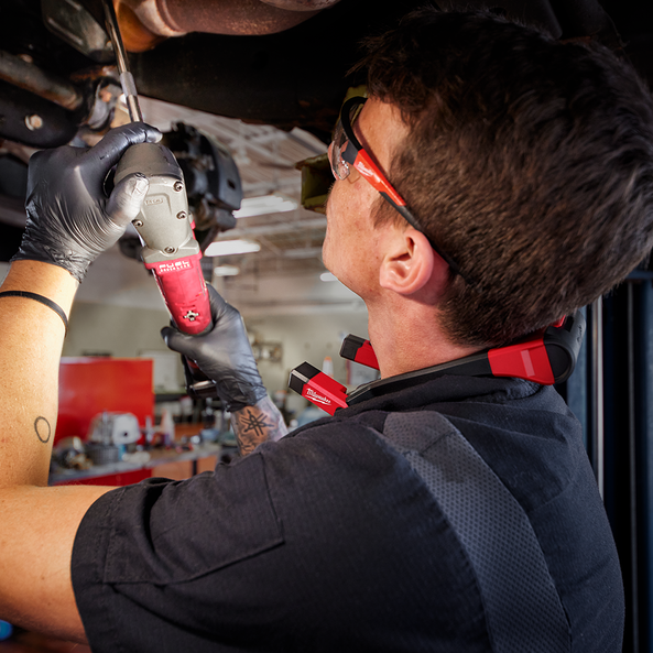 This is an image of a technician using a Milwaukee power tool for vehicle repair in a workshop, representing Kennedys Welding Supplies in Derwent Park, TAS, offering tool shop and power tool repairs