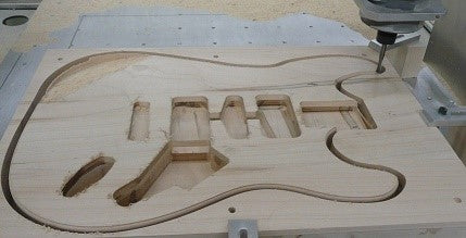 This is an image of a guitar body being laser cut from wood by CNC machine at Kennedys Welding Supplies, Derwent Park, TAS offering tool shop and laser cutting services
