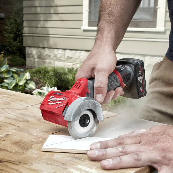 This is an image of a person using a Milwaukee cordless rotary tool cutting a tile, showcasing power tools at Kennedys Welding Supplies in Derwent Park, TAS