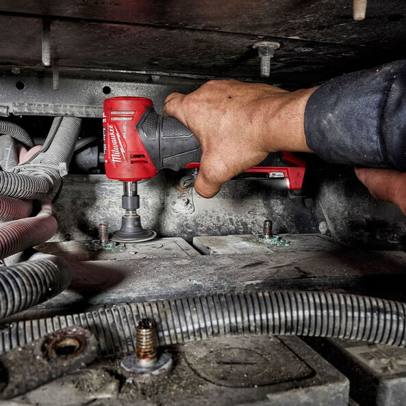 This is an image of a hand using a Milwaukee power tool inside a confined mechanical space, showcasing Kennedys Welding Supplies in Derwent Park TAS with tool shop and power tool repairs services