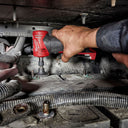This is an image of a hand using a Milwaukee power tool inside a confined mechanical space, showcasing Kennedys Welding Supplies in Derwent Park TAS with tool shop and power tool repairs services