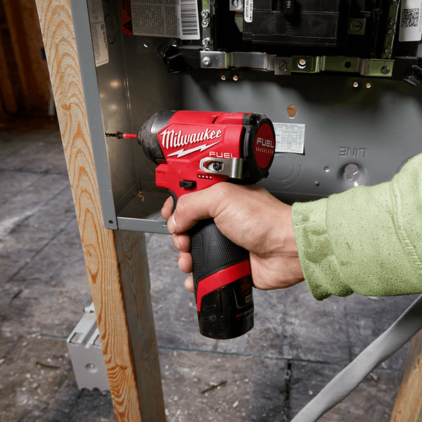 This is an image of a hand using a Milwaukee Fuel cordless drill on an electrical panel, featured by Kennedys Welding Supplies in Derwent Park TAS, offering tool shop and power tool repairs.