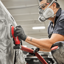 This is an image of a worker using a Milwaukee power tool for surface finishing, showcasing welding and tool repair at Kennedys Welding Supplies in Derwent Park, TAS