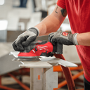 This is an image of a person using a red Milwaukee M12 FUEL power tool for metalwork at Kennedys Welding Supplies in Derwent Park, TAS, offering tool shop and welding specialist services.