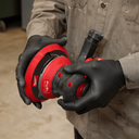 This is an image of a person wearing black gloves holding a red Milwaukee Fuel angle grinder, featured by Kennedys Welding Supplies in Derwent Park TAS, offering tool shop and welding specialist services