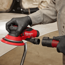 This is an image of a person using a red Milwaukee Fuel power sander, showcasing tool repair services by Kennedys Welding Supplies in Derwent Park, TAS