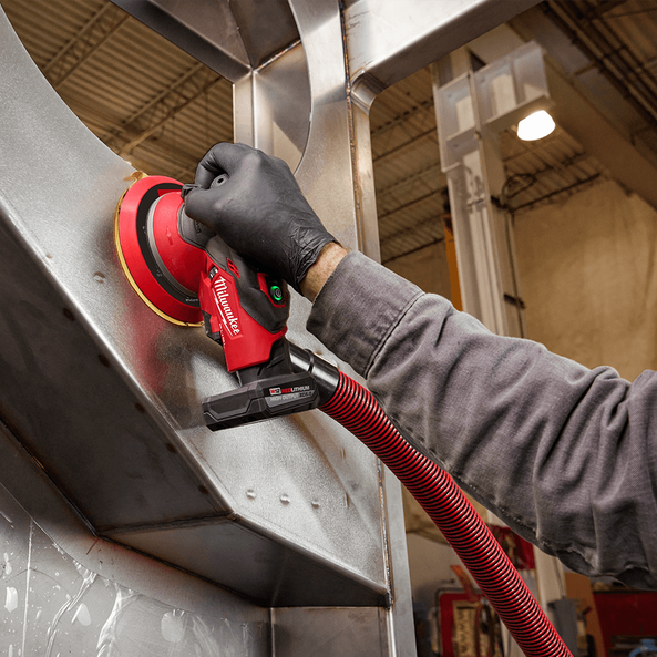 This is an image of a gloved worker using a Milwaukee power tool on metal, showcasing Kennedys Welding Supplies in Derwent Park, TAS