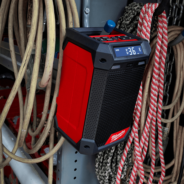 This is an image of a red Milwaukee jobsite Bluetooth speaker surrounded by ropes and tools at Kennedys Welding Supplies in Derwent Park, Tasmania, offering tool shop and welding specialist services.