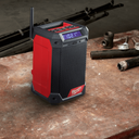 This is an image of a Milwaukee M12 cordless jobsite radio on a workshop table at Kennedys Welding Supplies, Derwent Park TAS, offering tool shop and welding specialist services