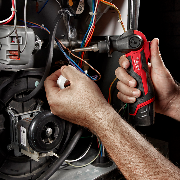This is an image of hands using a Milwaukee power tool for electrical wiring repair at Kennedys Welding Supplies in Derwent Park TAS, offering tool shop and power tool repairs