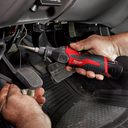 This is an image of hands using a Milwaukee power tool under a vehicle dashboard, showcasing Kennedys Welding Supplies services in Derwent Park TAS