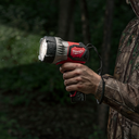 This is an image of a hand holding a wet Milwaukee flashlight, showcasing durable power tools from Kennedys Welding Supplies in Derwent Park TAS, experts in welding, tool shop, and power tool repairs.