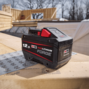 This is an image of a Milwaukee M18 REDLITHIUM 12.0 Ah battery at a woodworking site, featured by Kennedys Welding Supplies in Derwent Park, TAS offering tool shop and welding specialist services