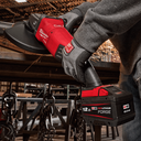 This is an image of a worker using a red Milwaukee M18 FUEL 12.0Ah cordless angle grinder at Kennedys Welding Supplies in Derwent Park, Tasmania, offering tool shop and welding specialist services.
