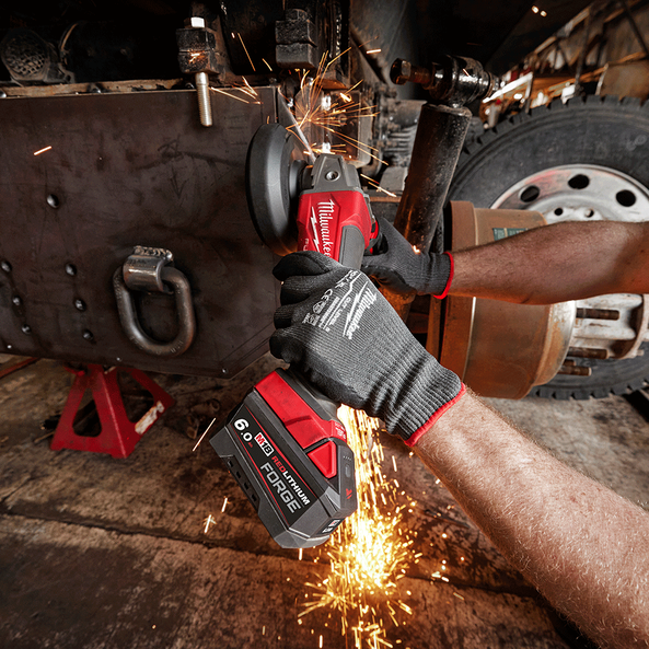 This is an image of a person using a Milwaukee M18 FUEL cordless angle grinder producing sparks, showcasing Kennedys Welding Supplies in Derwent Park TAS, tool shop and welding specialists