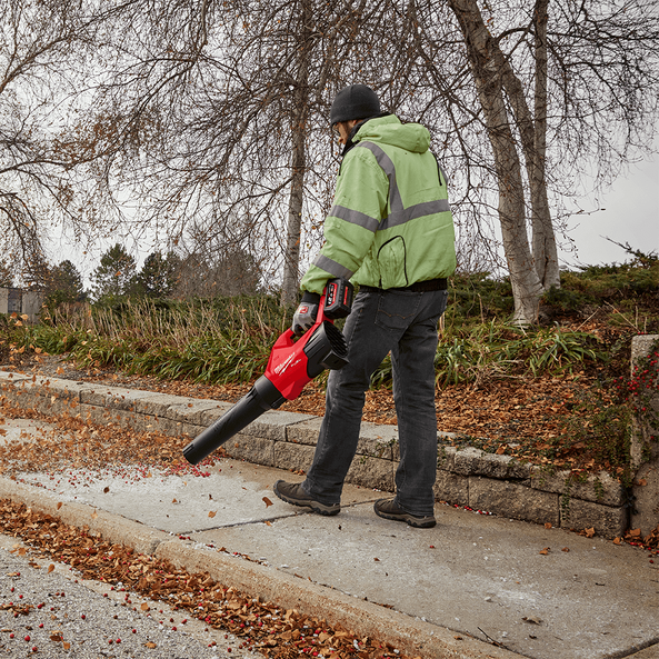 This is an image of a person using a red leaf blower outdoors in autumn, promoted by Kennedys Welding Supplies in Derwent Park TAS offering tool shop and power tool repairs