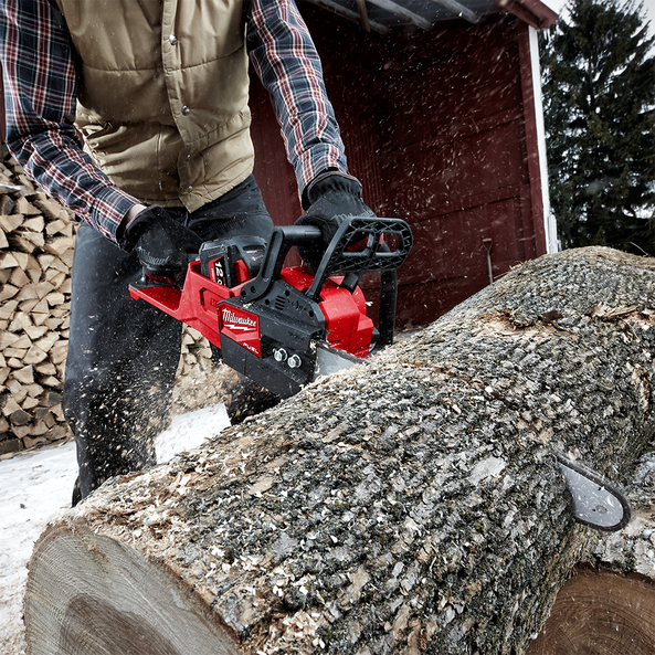 This is an image of a person using a red Milwaukee chainsaw to cut a large log outdoors, showcasing power tools from Kennedys Welding Supplies in Derwent Park, TAS, offering tool shop and power tool repairs.